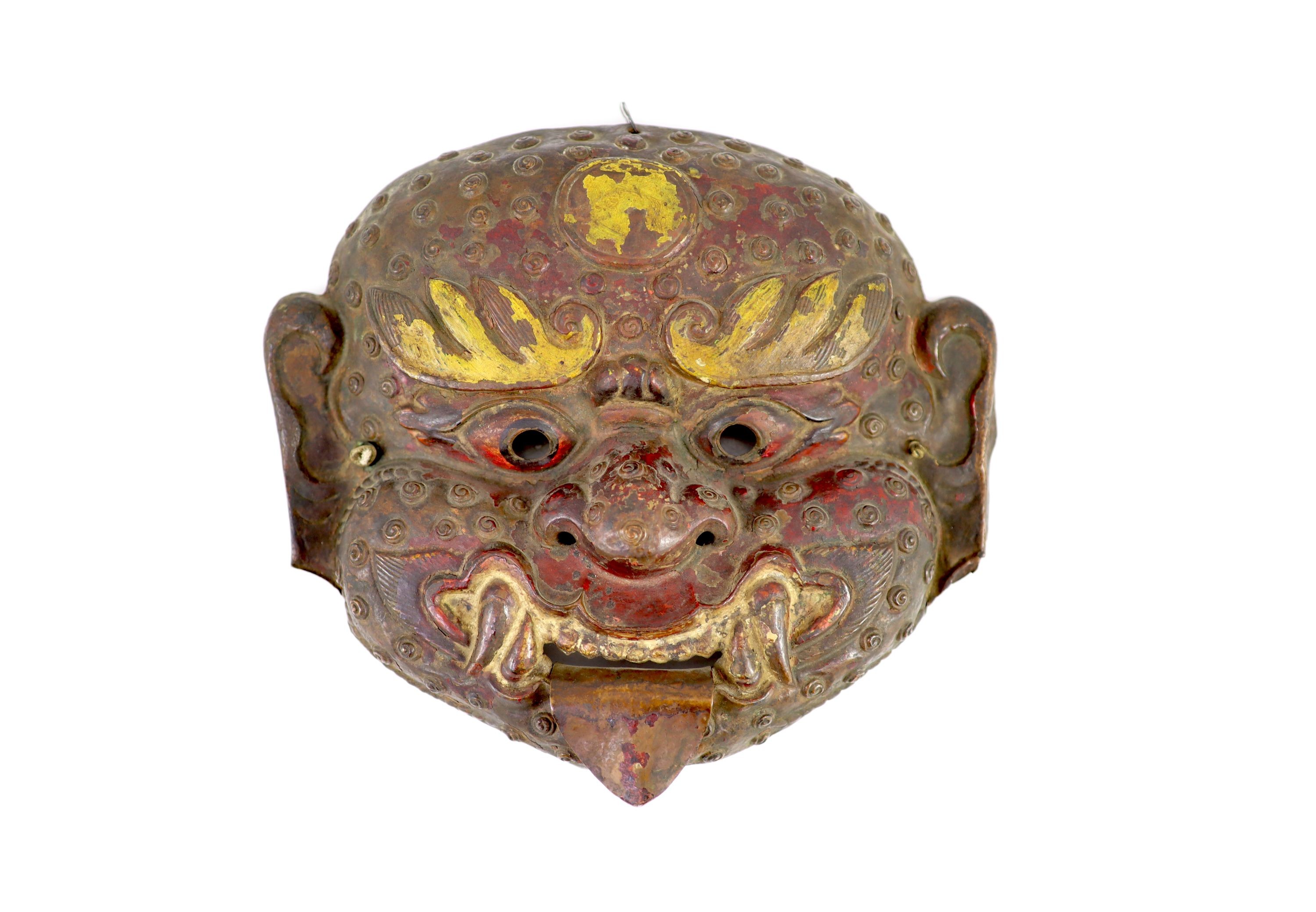 A Tibetan painted repoussé copper ‘demon’ mask, 17th/18th century, 28cm wide, 25cm high